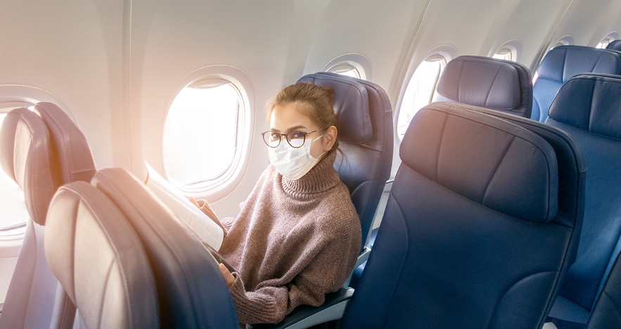 female passenger wearing mask on plane