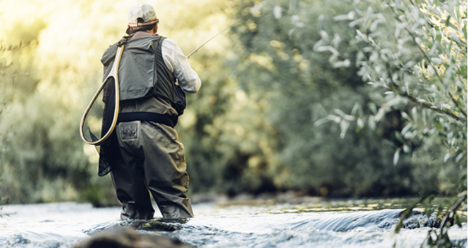 man flyfishing in beautiful river